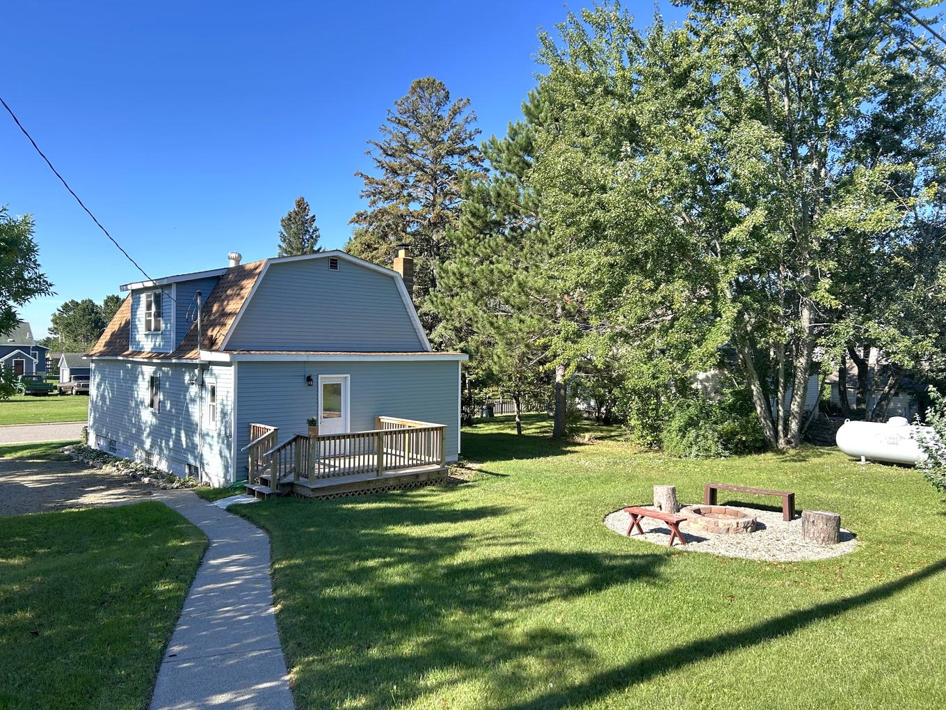 Side elevation of the house with the fire pit in the foreground