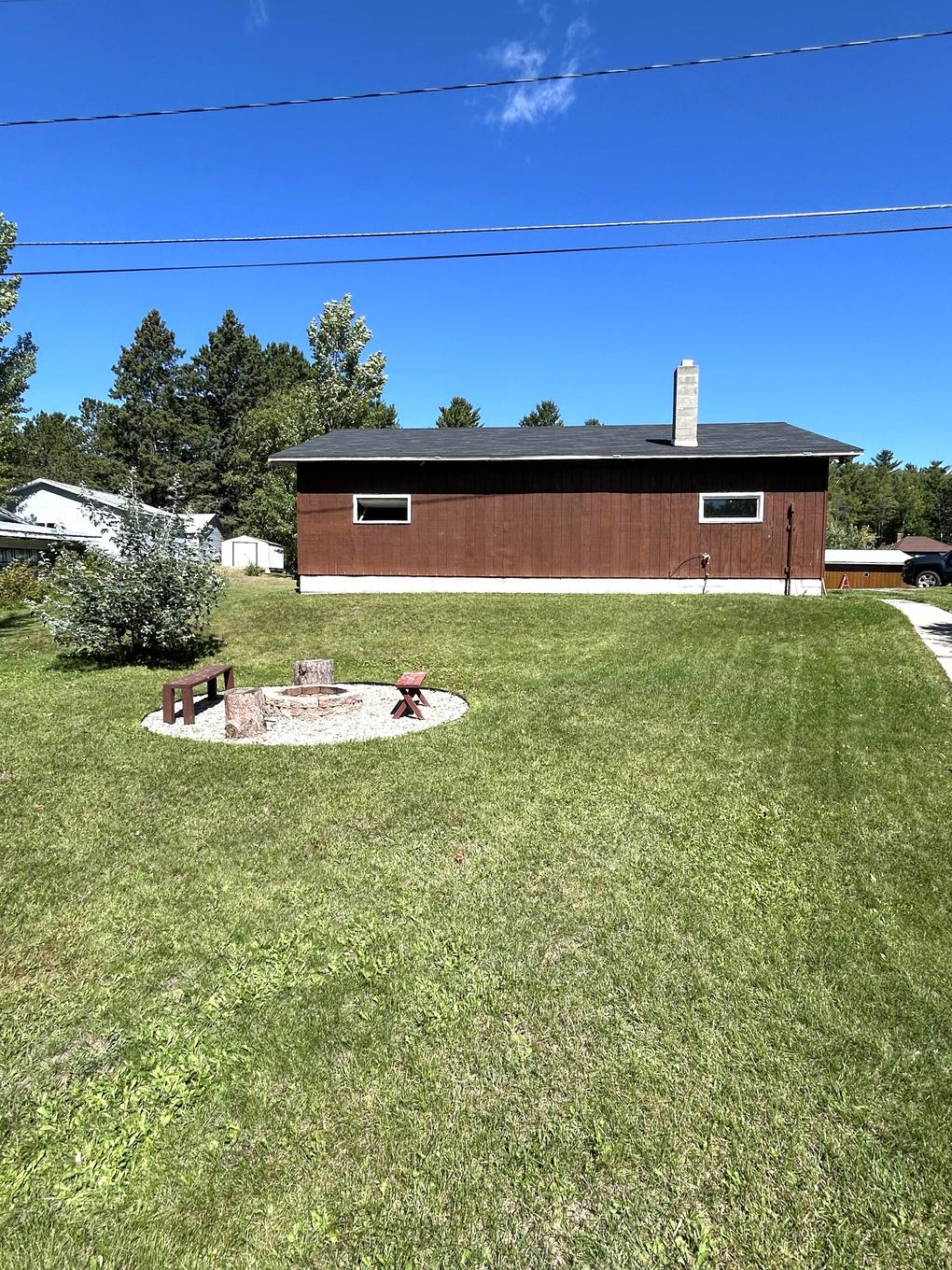 Backyard fire pit with the garage-workshop building beyond
