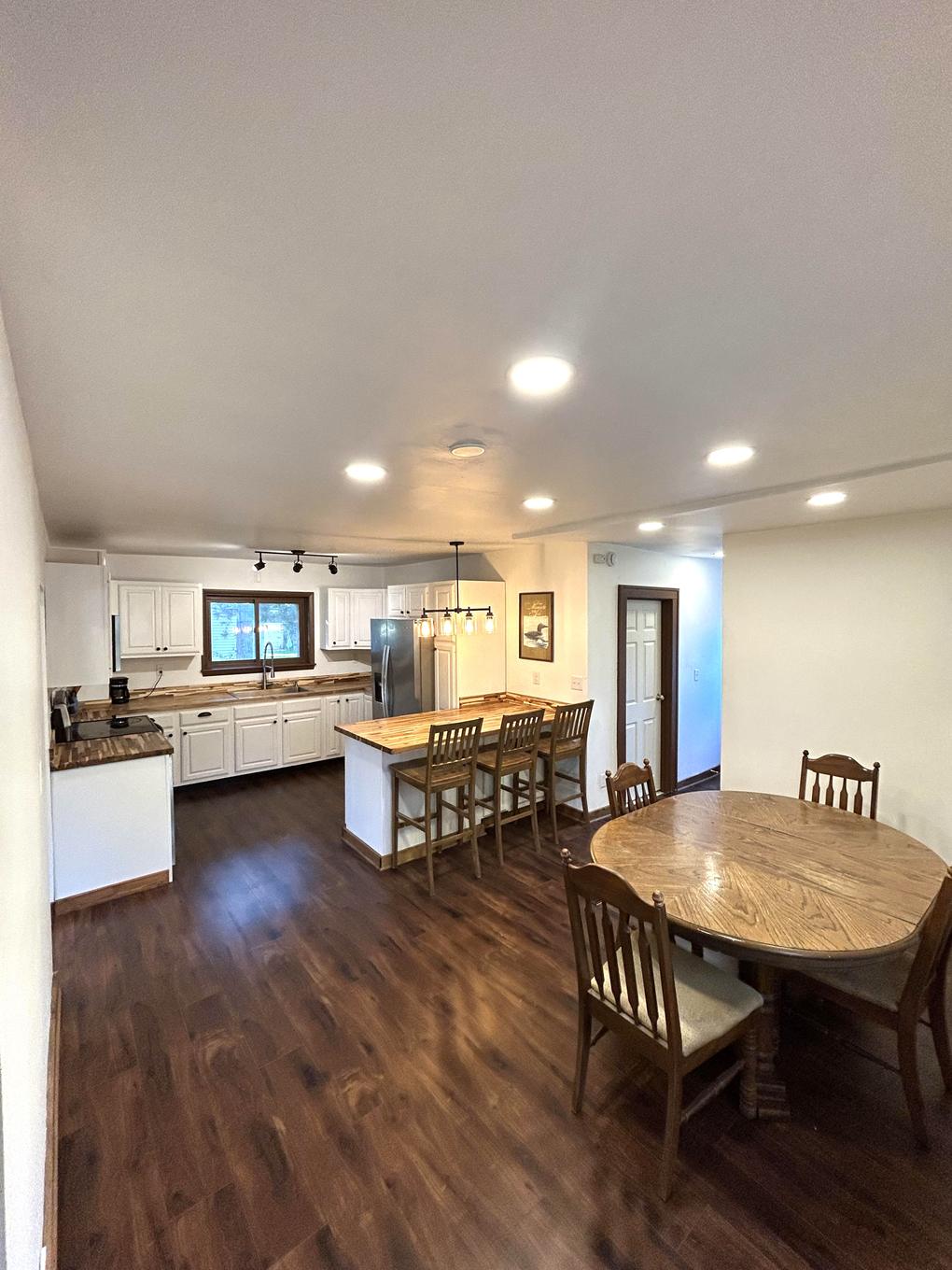 Kitchen open to a round dining table and chairs
