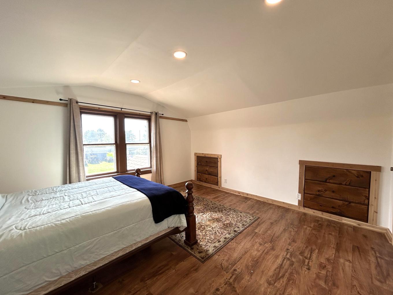 Primary bedroom with built-in dressers along the wall