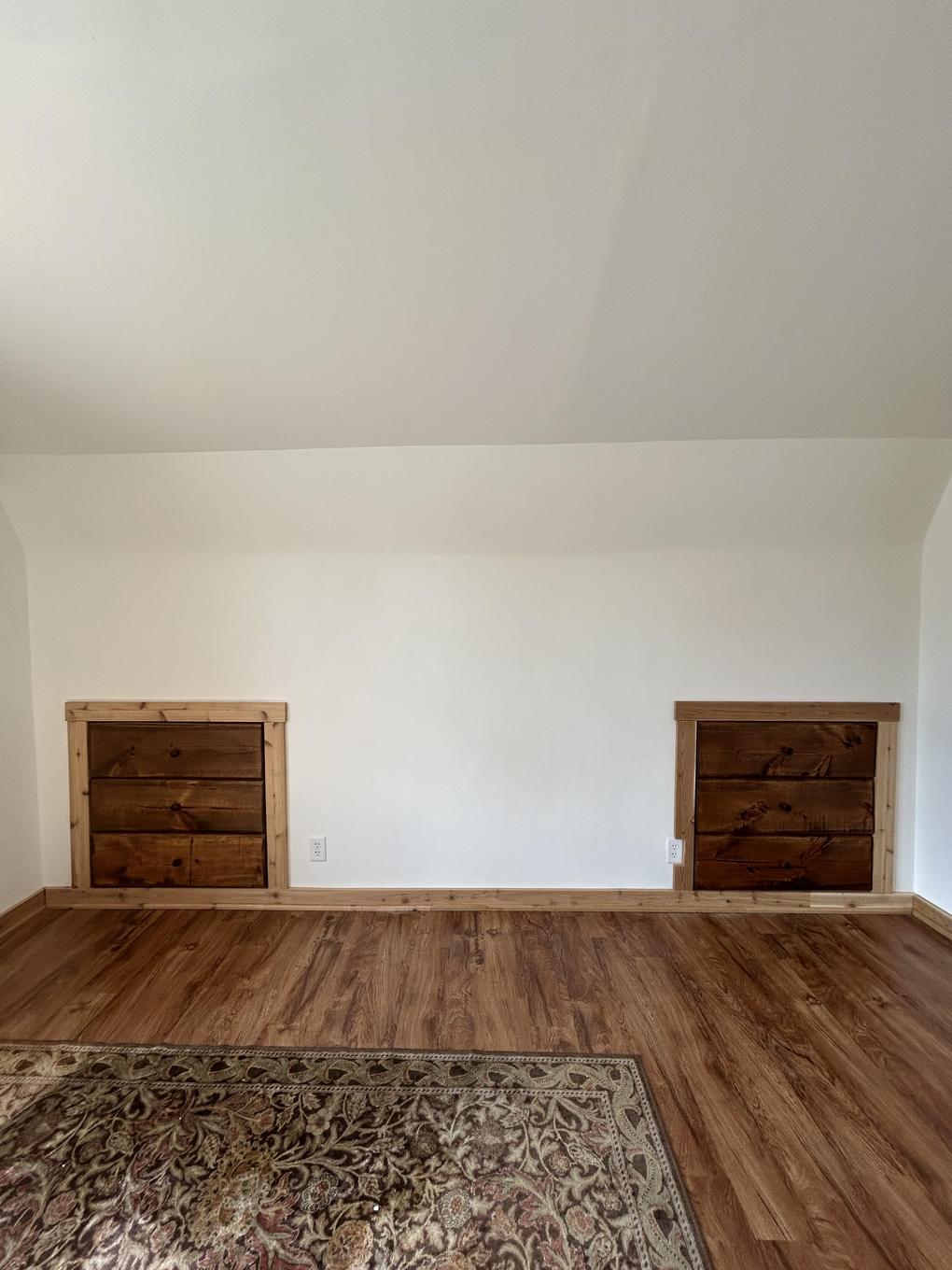 Built-in dressers flanking an upstairs bedroom wall