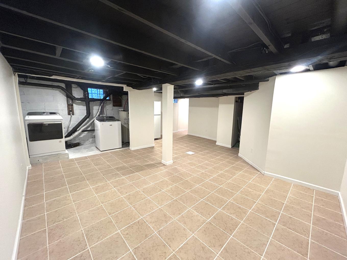 Finished lower level with tile flooring and open rec space