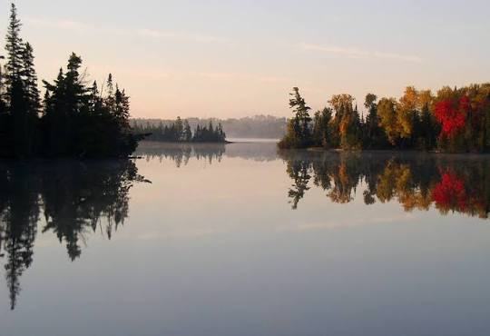 Misty morning on Bear Head Lake, with islands and fall color along the shore