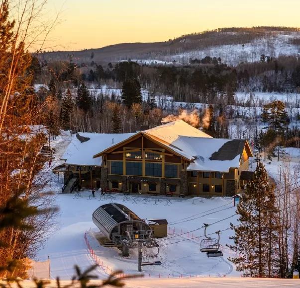 The lodge at Giant's Ridge at dusk with the chairlift in the foreground